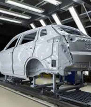 Technicians using advanced frame straightening equipment to restore a vehicle to factory specifications