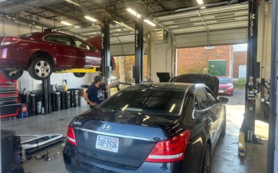 Skilled mechanic performing meticulous auto glass replacement and bumper repair service