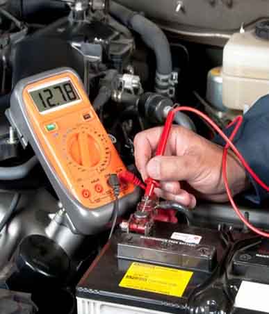 Technician meticulously repairing the electrical and air conditioning systems of an automobile