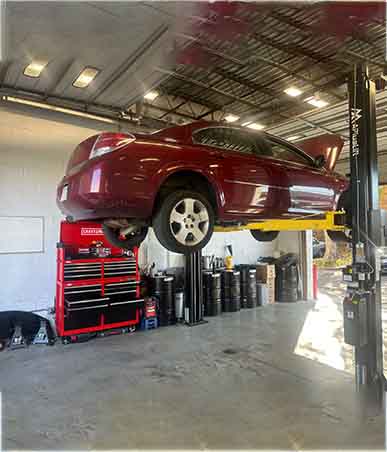 State-of-the-art computerized wheel alignment machine actively adjusting a vehicle's wheels